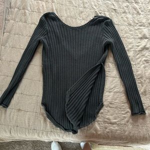 Deep cut black sweater! High slit along the side and hits mid way.